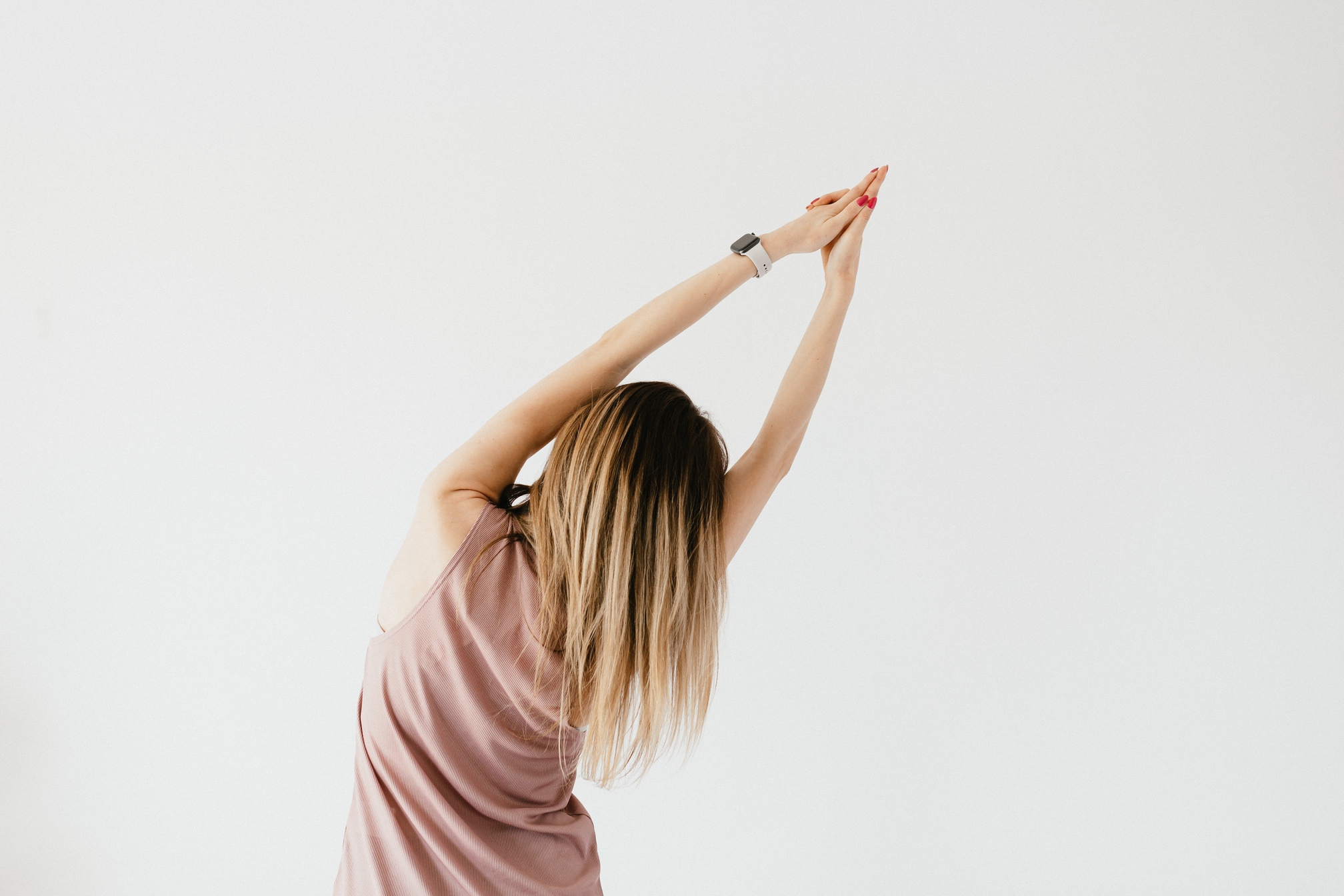 Unrecognizable young woman warming up arms before training